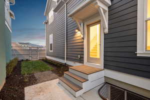 Doorway to property featuring a patio and a gate