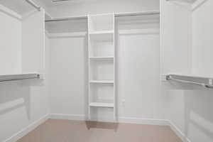 Spacious closet with carpet flooring