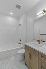 Bathroom featuring vanity, shower / washtub combination, and light marble finish flooring