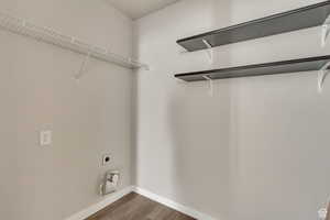 Laundry room with wood finished floors and hookup for an electric dryer