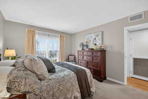 Bedroom with light carpet and baseboards