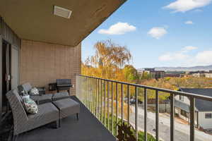 Balcony featuring grilling area and a city and mountain view