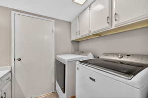 Laundry room featuring cabinet space and washing machine and dryer