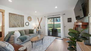 Living room with wood finished floors and recessed lighting