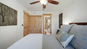 Bedroom featuring ensuite bath, a ceiling fan, and a closet