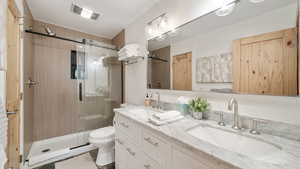 Bathroom with double vanity and a shower stall