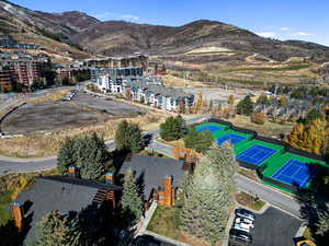 Aerial overview of property's location with a mountainous background and nearby suburban area