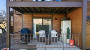 View of patio with a grill