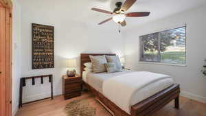 Bedroom featuring wood finished floors and a ceiling fan