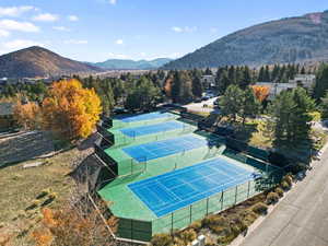View of tennis court with a mountain view