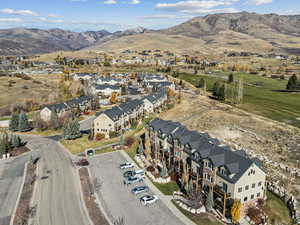Aerial view of property's location with mountains and nearby suburban area