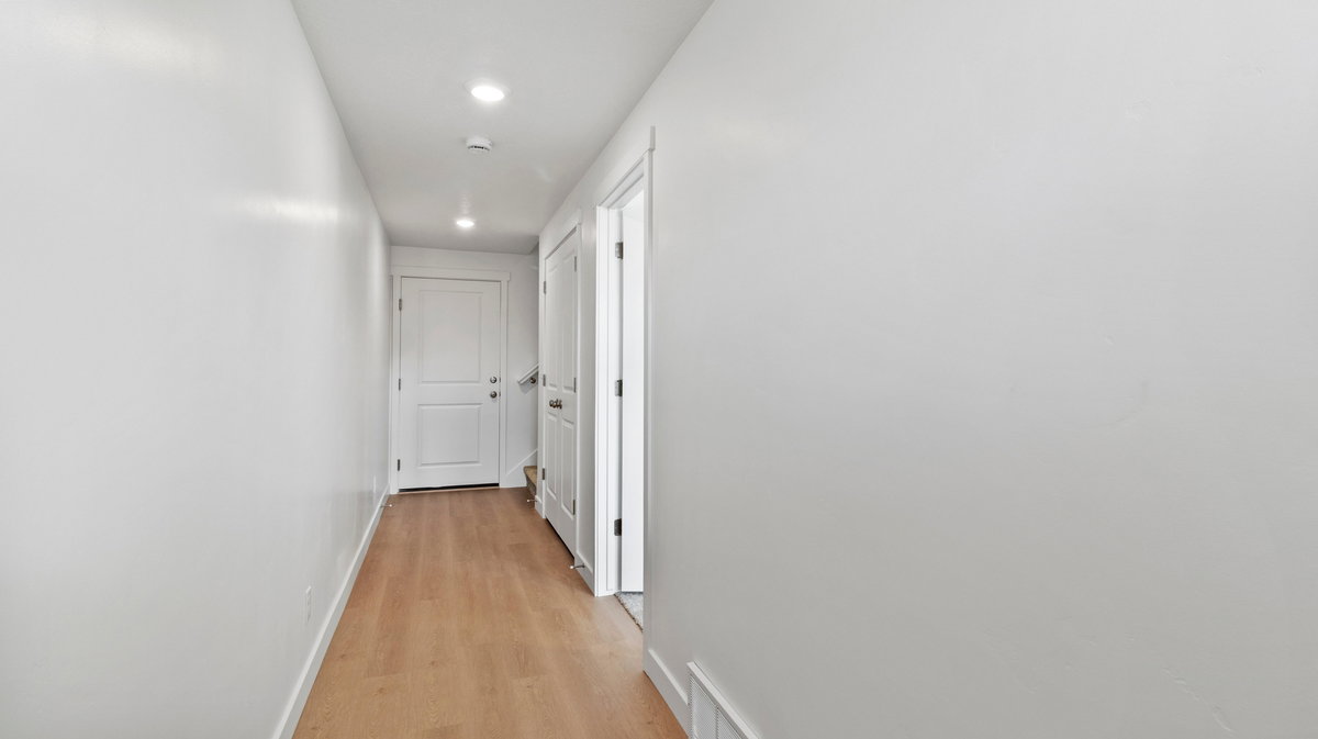 Hallway featuring light wood-type flooring and recessed lighting