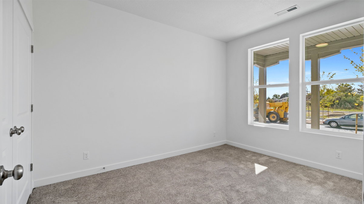 Carpeted empty room with baseboards