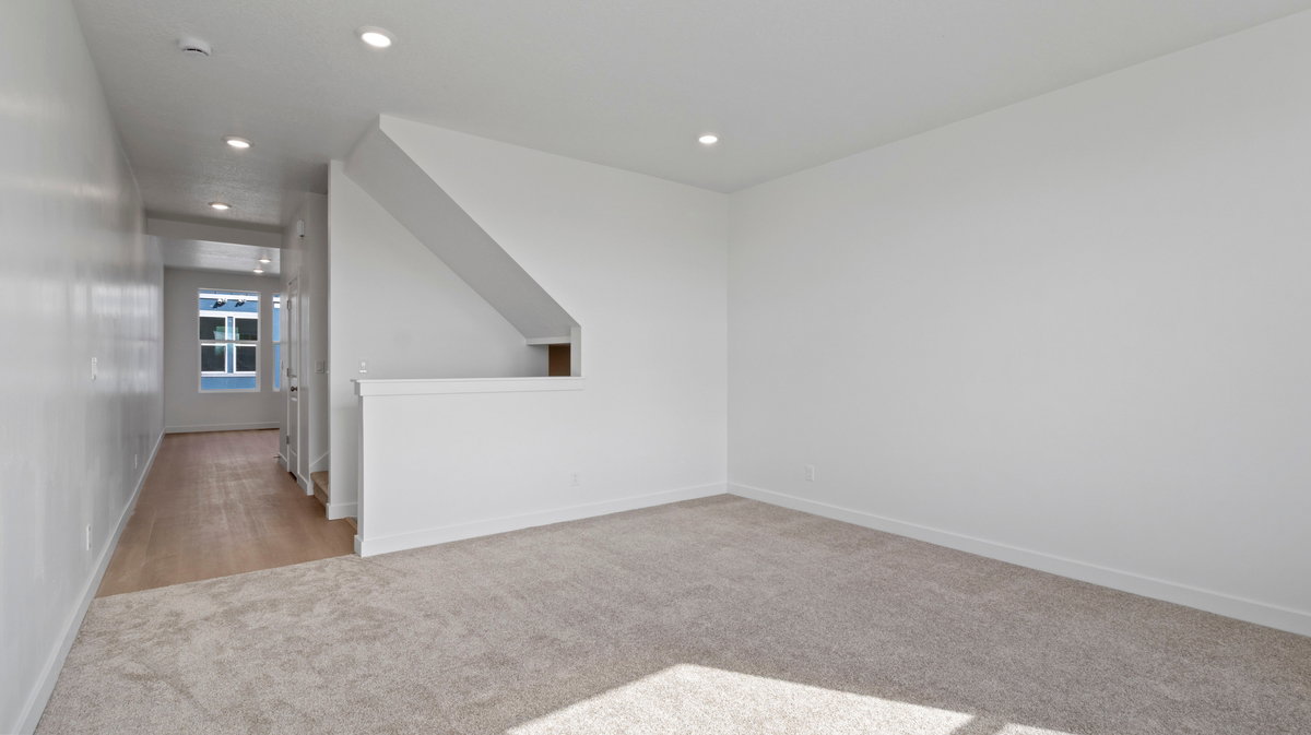 Empty room featuring light carpet and recessed lighting