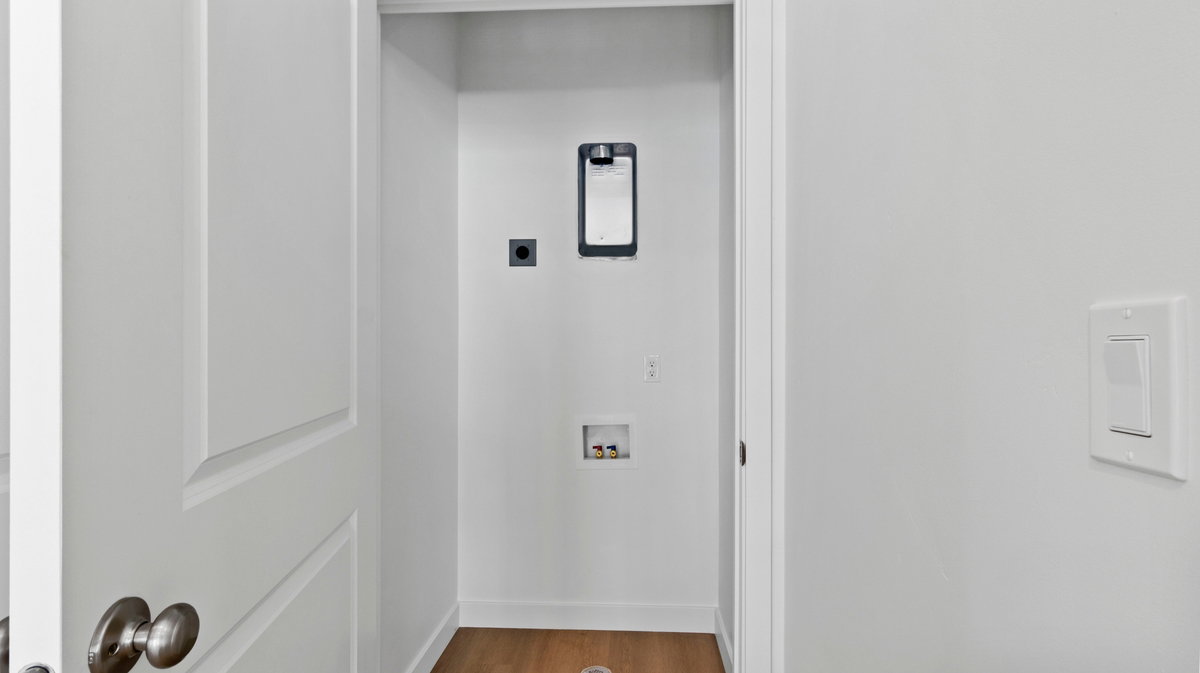 Laundry room featuring wood finished floors, hookup for a washing machine, and electric dryer hookup