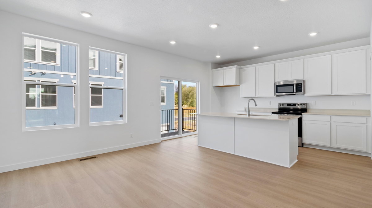 Kitchen featuring white cabinetry, stainless steel appliances, a center island with sink, recessed lighting, and light wood-type flooring