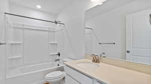 Full bath featuring tub / shower combination and vanity