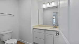 Half bath with vanity and toilet