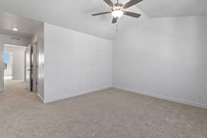 Bonus room featuring light carpet, a ceiling fan, and lofted ceiling
