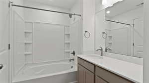 Bathroom with vanity, tub / shower combination, and recessed lighting