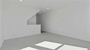 Carpeted spare room featuring baseboards and recessed lighting