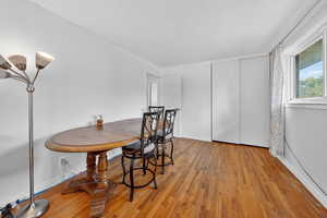 Dining area featuring wood finished floors and baseboards