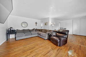 Living area featuring light wood-type flooring and a textured ceiling