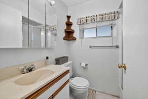Full bath featuring vanity and a shower with shower door