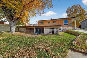 Back of property featuring brick siding