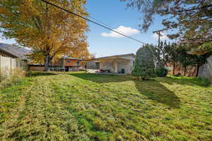 Back of property featuring a trampoline, a patio, and a fenced backyard
