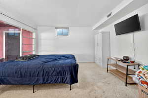 Bedroom with carpet and a textured ceiling