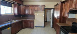 Kitchen with electric range oven, dishwasher, under cabinet range hood, and brown cabinetry