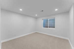 Spare room with light colored carpet and recessed lighting