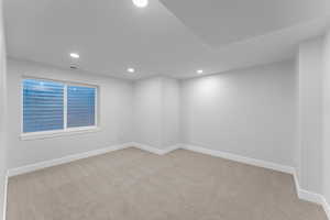 Unfurnished room with light carpet and recessed lighting