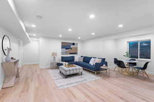 Living room featuring recessed lighting and light wood-type flooring