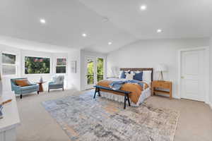 Bedroom featuring light colored carpet, lofted ceiling, access to exterior, and recessed lighting