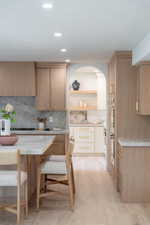Kitchen with brown cabinets, open shelves, modern cabinets, recessed lighting, and backsplash