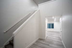 Staircase featuring wood finished floors and baseboards