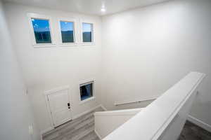 Stairs featuring wood finished floors and baseboards