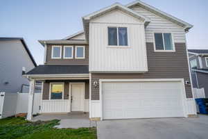 View of front of home featuring board and batten siding, a porch, driveway, an attached garage, and a shingled roof