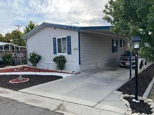 View of home's exterior with driveway and a carport