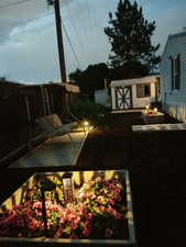 View of yard featuring a storage unit, an outdoor fire pit, and a patio