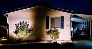 Property exterior at night with a carport