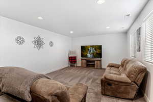 Living room with recessed lighting and carpet floors