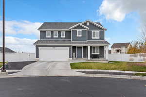 View of front of home featuring a porch, concrete driveway, a garage, and roof with shingles