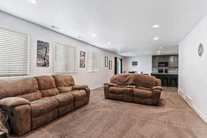 Living area with carpet and recessed lighting