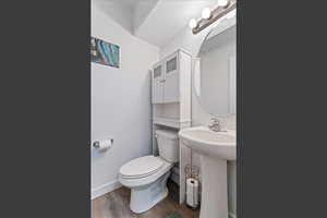 Bathroom with light wood finished floors and toilet