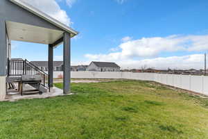 Fenced backyard featuring a patio area and a residential view