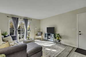 Living room/family room with sliding door that walks out to a balcony