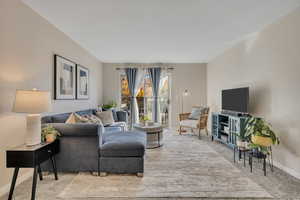 Living room/family room with sliding door that walks out to a balcony